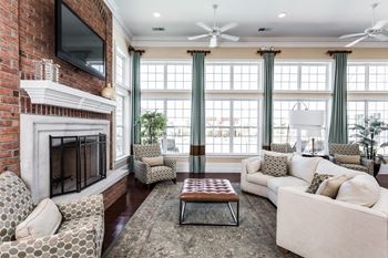 A living room with a brick fireplace and a couch and a coffee table